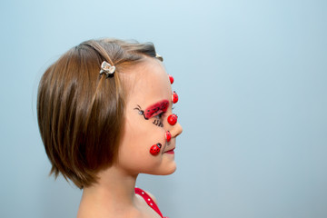 Little girl with ladybug face paint