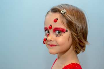 Little girl with ladybug face paint