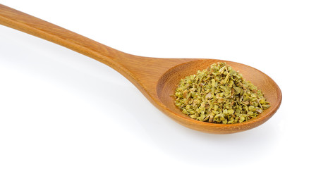 Dried oregano in wood spoon on white background