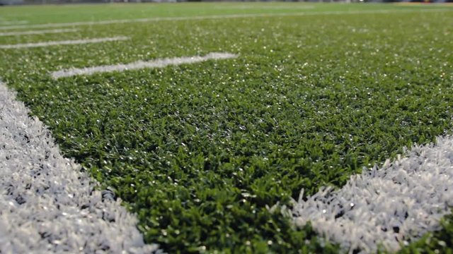 Close up boundary line on a turf football field.