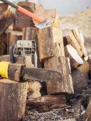 Electric saw chain on the background of sawn timber.