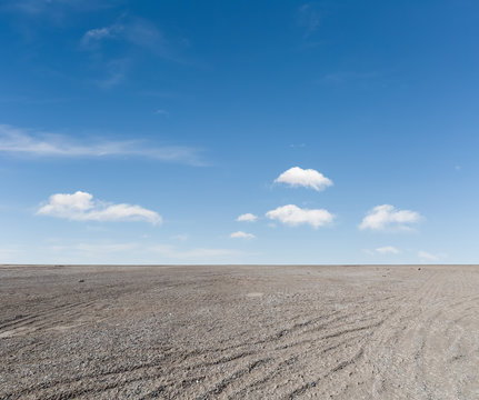 Fototapeta blue sky and gravel ground
