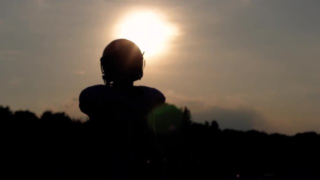 Silhouetted wide receiver warming up during pregame drills