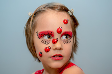 Little girl with ladybug face paint