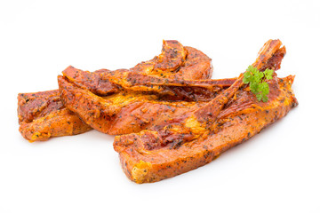 Spicy marinated spare ribs barbecued on the white background.