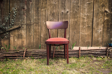 Wooden Chair in Front of Old Garden Barn