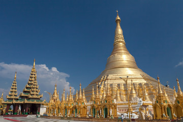 Fototapeta premium Shwedagon Pagoda in daytime with blue sky, the Pagoda is a famous tourist place in Yangon.Myanmar Burma.