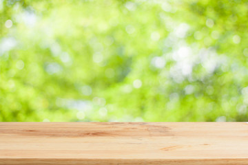 Wood table top on bokeh Green background