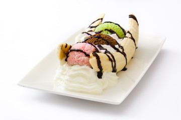 Banana split ice cream dessert with chocolate syrup isolated on white background

