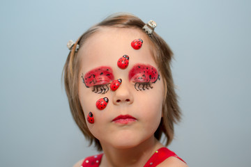 Little girl with ladybug face paint