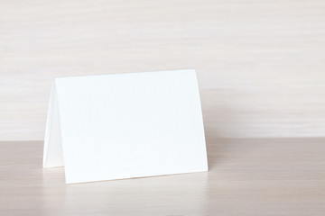 Blank paper business card on wooden desk, office style wallpaper