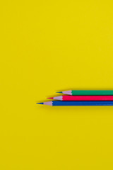 Crayons, green, red, blue, yellow background
