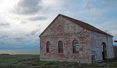 Fototapeta premium Red Brick Fog Signal Building at Piedras Blancas Lighthouse point on the Central Coast of California USA