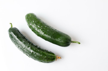 Fresh cucumbers on white wooden table