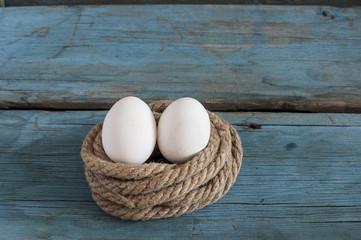 fresh chicken eggs lay on the wooden table