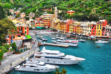 The beautiful Portofino with colorful houses and villas, luxury yachts and boats in little bay...