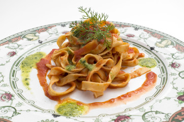 tagliatelle with tomato sauce, italian pasta, on an old plate
