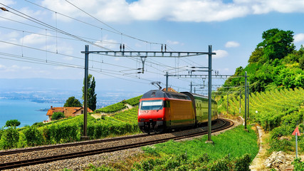 Fototapeta premium Train at railroad at Lavaux Vineyard Terrace Lake Geneva Alps