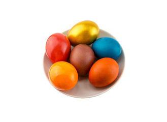 Six bright orange eggs and gold lie on a ceramic saucer on a white isolated background