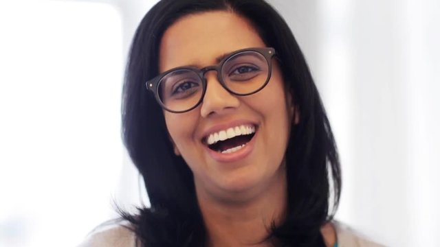 happy smiling indian young woman in glasses