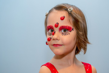 Little girl with ladybug face paint
