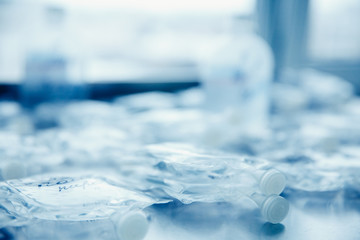 Dropper in a vein close-up. Blue background. The concept of body cleansing