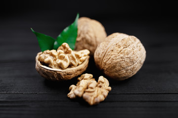 Walnut and walnut kernel on the black background.