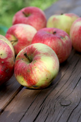 Red apples on the bench closeup