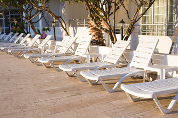 Beach chairs near swimming pool