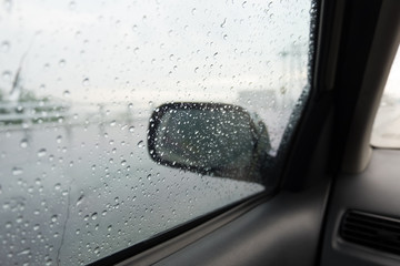Rain drops car side view mirror.