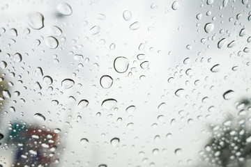 Blurry blackdrop.Drop of rain on a car windshield.
