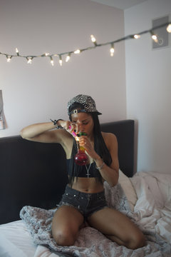 Young woman smoking a bong