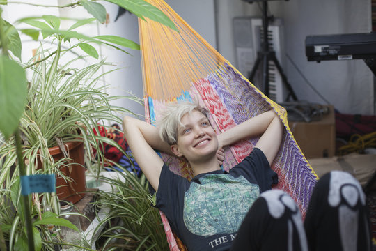 Smiling young woman relaxing on hammock