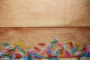  paper clips on wooden background