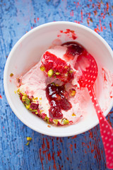 Raspberry vanilla semifreddo with raspberry sauce and pistachio