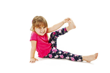 Little girl makes gymnastic exercise. Isolated on white background