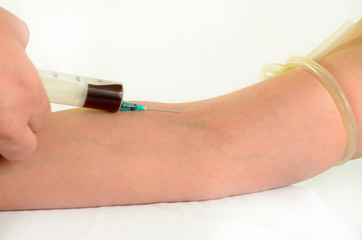 Blood sampling and analysis in a biochemical laboratory on a light background.