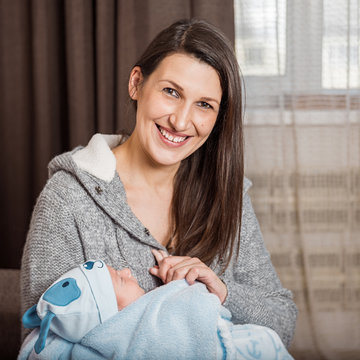 Portrait of a happy family. A woman with a newborn child