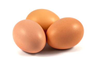 Three brown chicken eggs isolated on white
