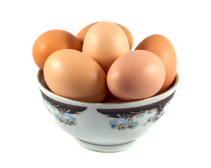 brown chicken eggs in a cup isolated on white