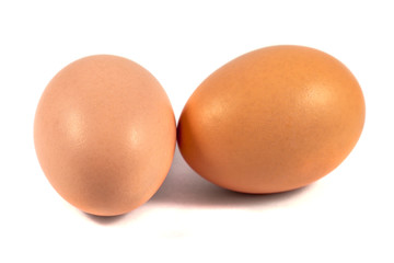 Two brown chicken eggs isolated on white