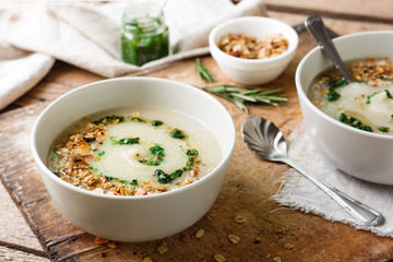 Celery cream soup with green oil and granola