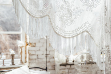 Interior in boho style, bedroom with white tulle