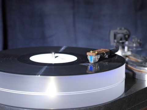 Audiophile HiFi turntable player with musical vinyl record.