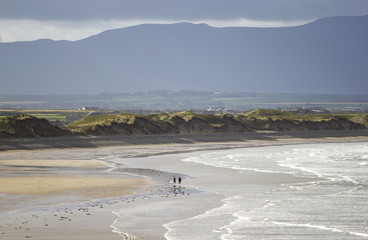 Couple walking on a quiet beach, County Kerry ,Ireland 