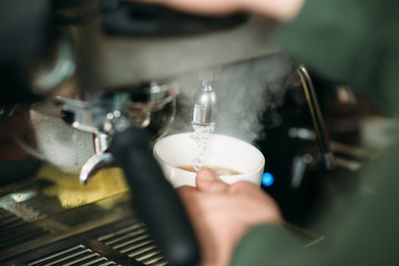 Focused male hands with white cup