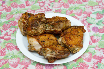 Fried chicken thighs on a white plate
