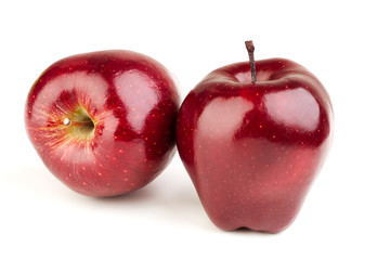 Two ripe juicy red apples on a white background