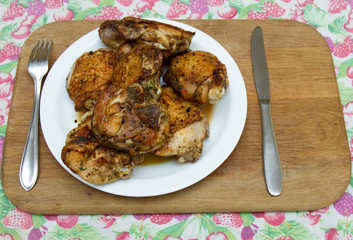 Fried chicken thighs on a white plate
