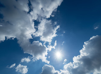 blue and very cloudy sky on a sunny day
